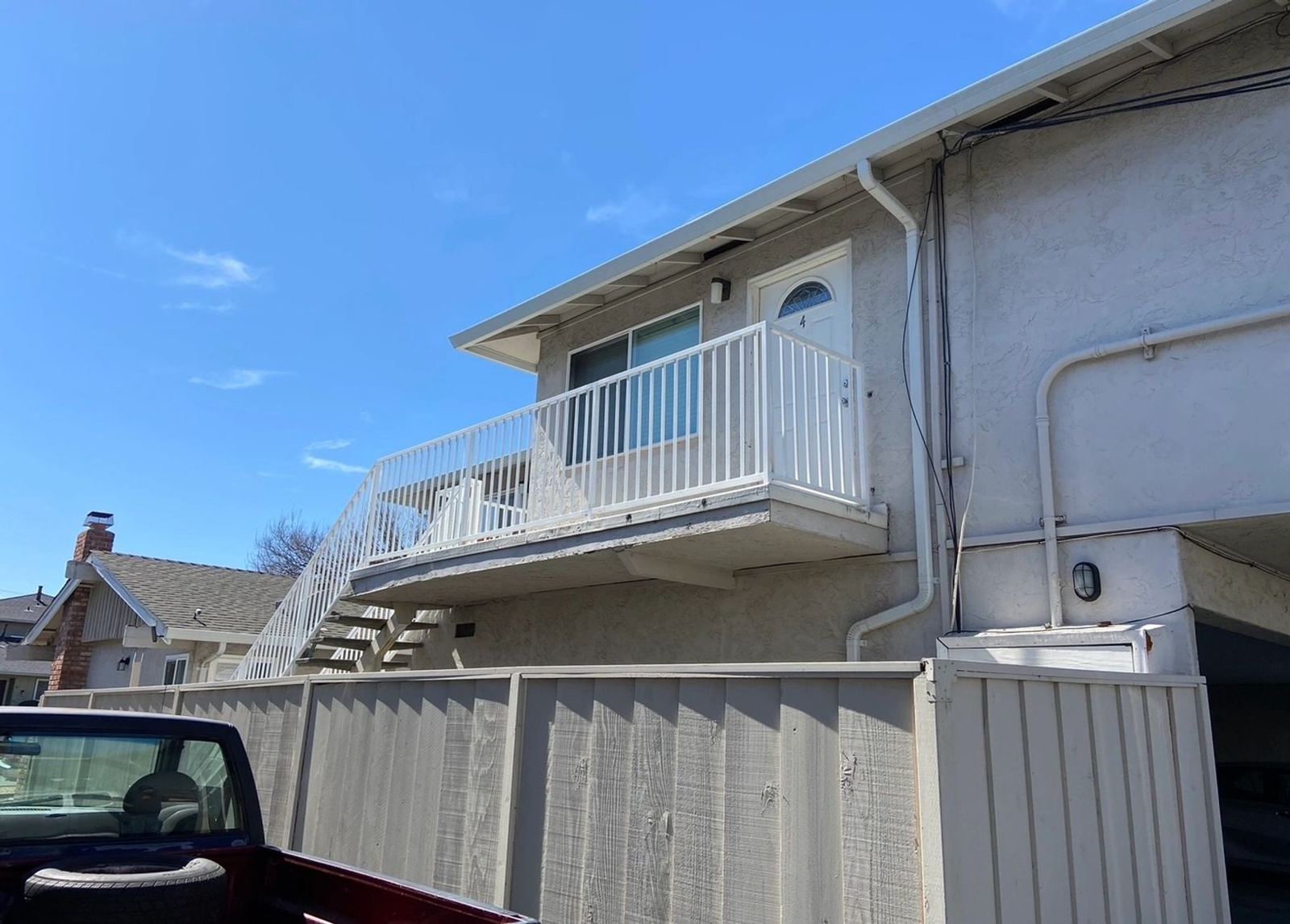 A white balcony railing installed on a two-story home