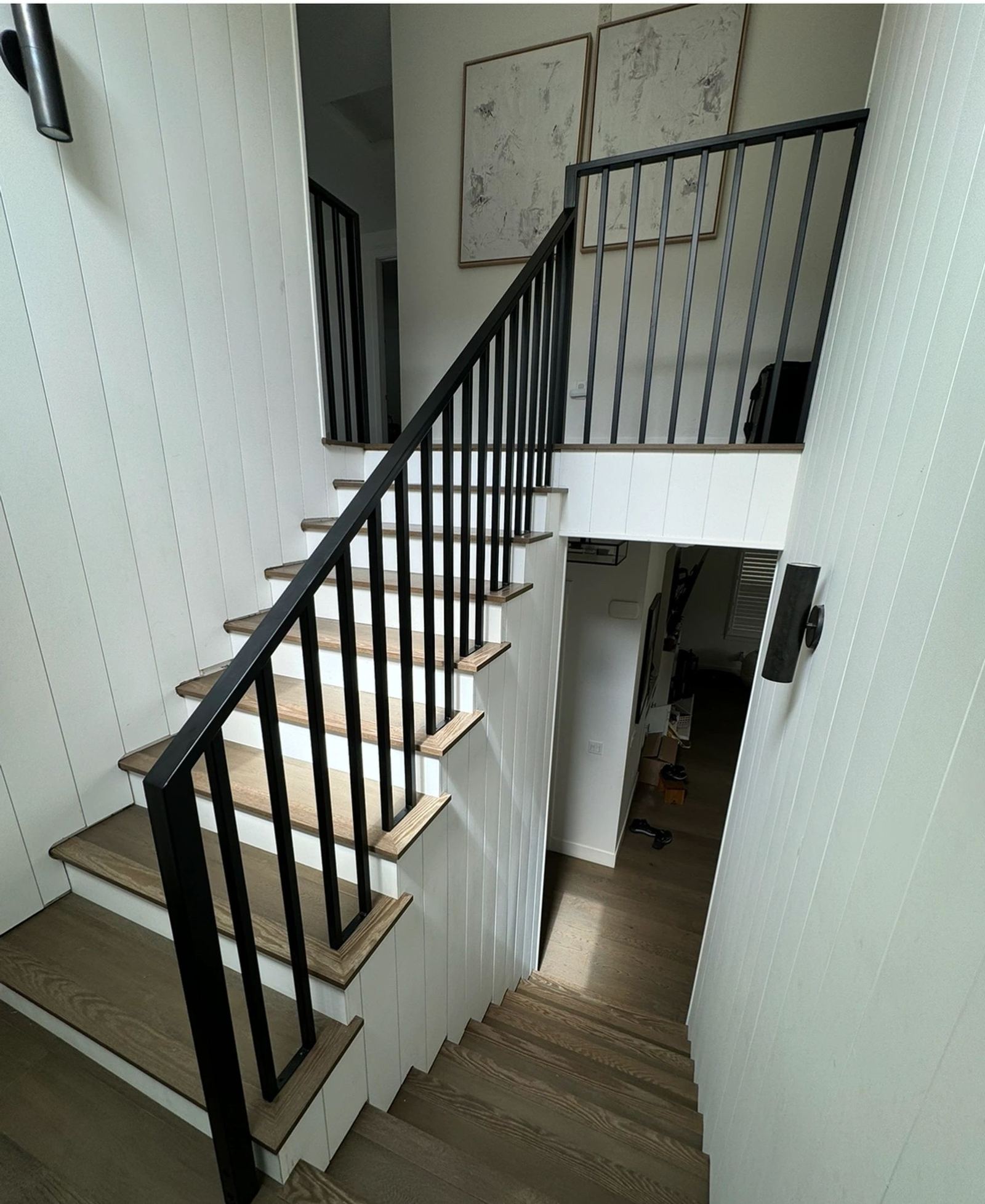 A black interior stair railing on a residential staircase, an ATR Welding installation