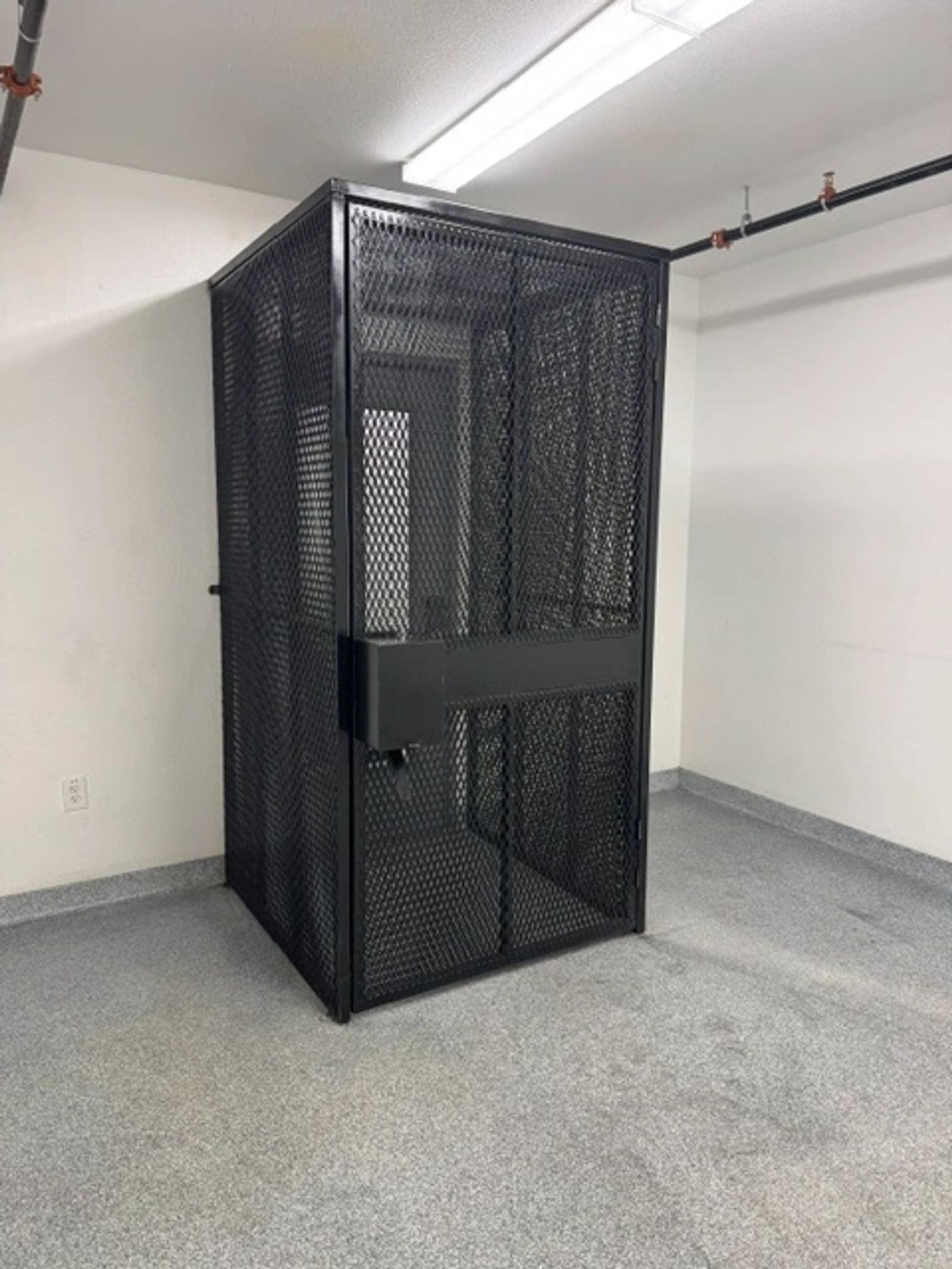 A black mesh interior storage security cage